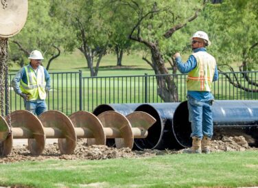 closeup of crew members working on Rochelle Blvd